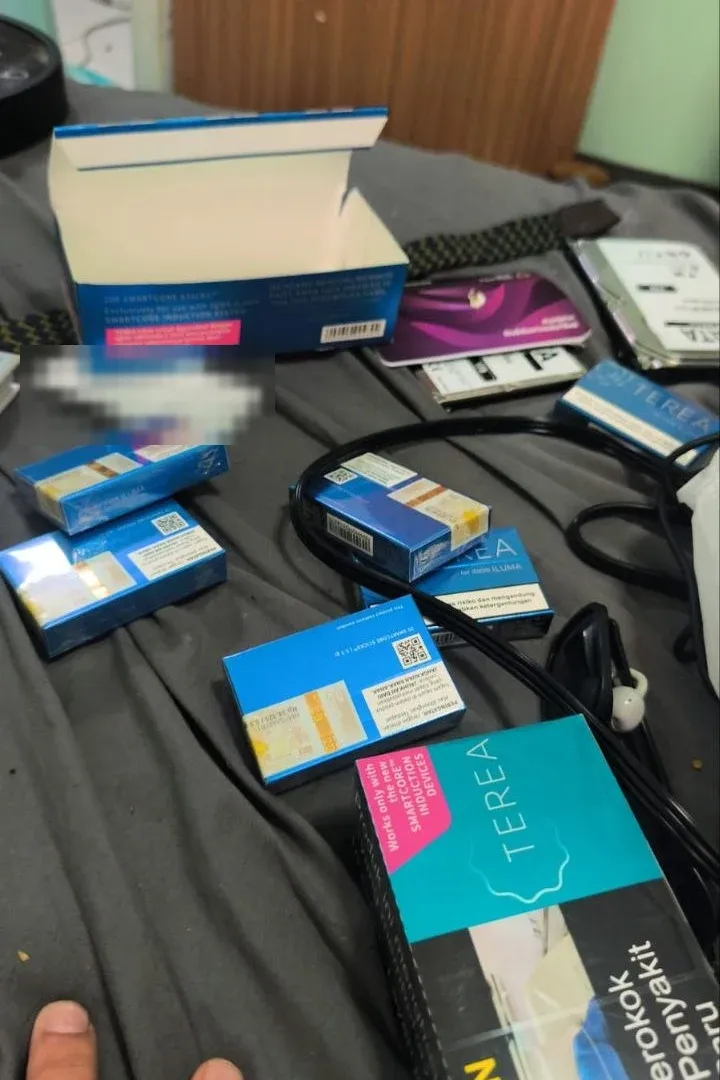 TEREA packs from an opened carton spread out on a bed